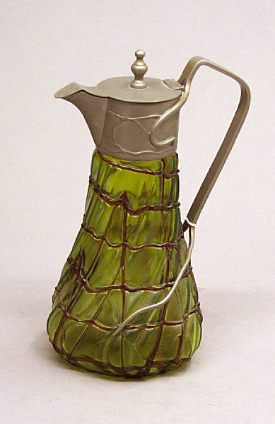 Appraisal: An Austrian iridescent glass and metal mounted claret jug early