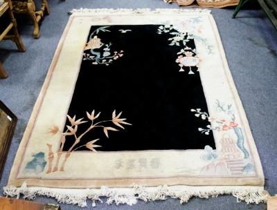 Appraisal: A Chinese washed rug with black central ground and white