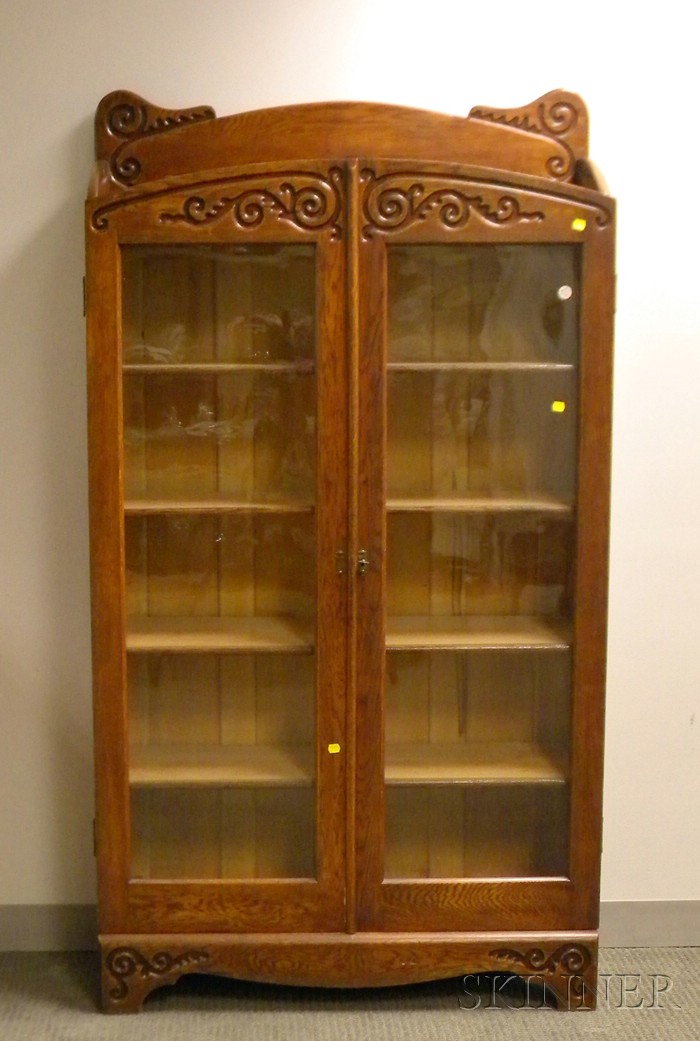 Appraisal: Late Victorian Glazed Carved Oak Two-Door Bookcase the interior with