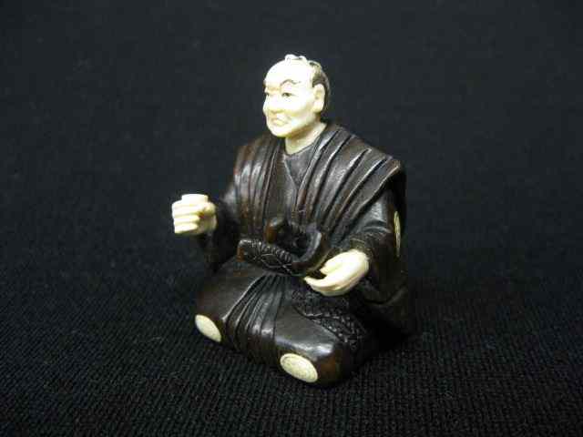 Appraisal: Carved Ivory Boxwood Netsuke of a seated Samarai warrior signed