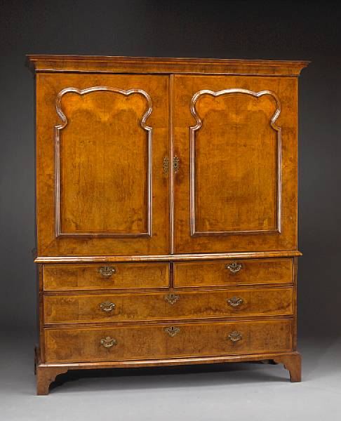 Appraisal: A George I crossbanded and inlaid walnut linen press The