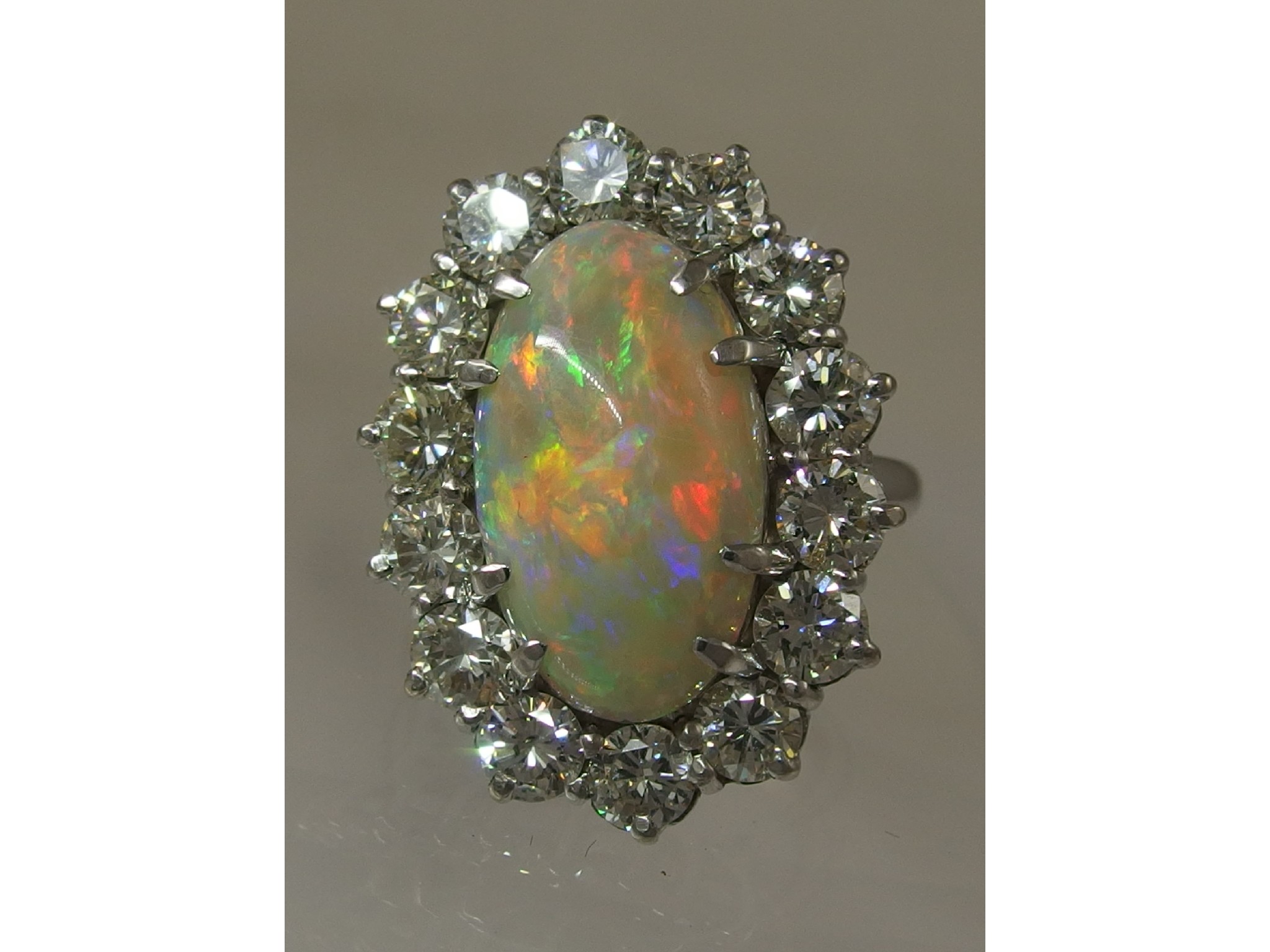 Appraisal: An ct white gold opal and diamond cluster ringthe high