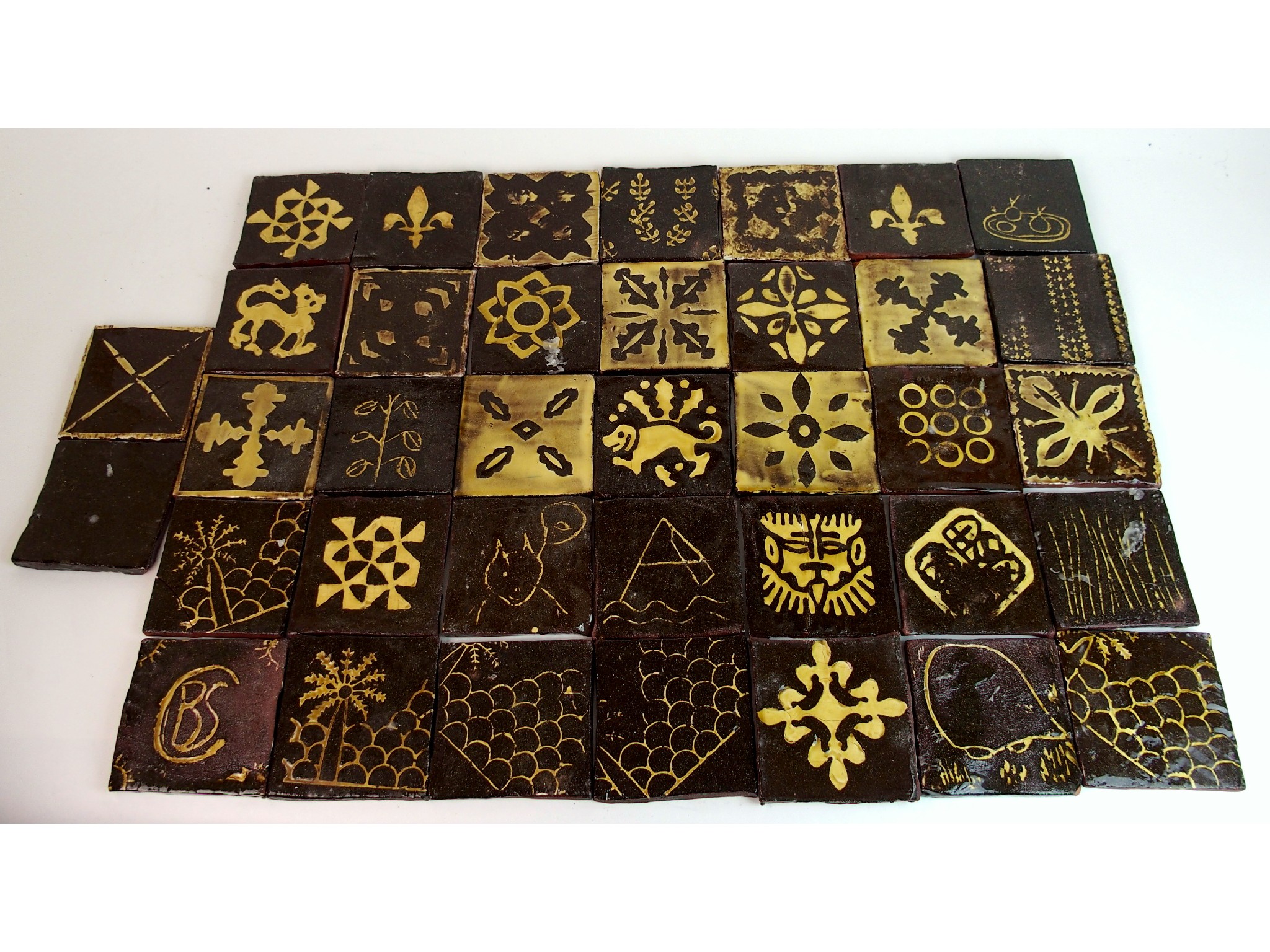 Appraisal: A collection of thirty-seven brown encaustic tilesbrown and cream square