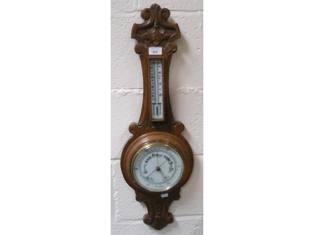 Appraisal: An Edwardian carved oak aneroid wheel barometer cm high