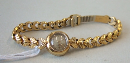 Appraisal: A lady's gold cased rear winding Omega bracelet wristwatch the