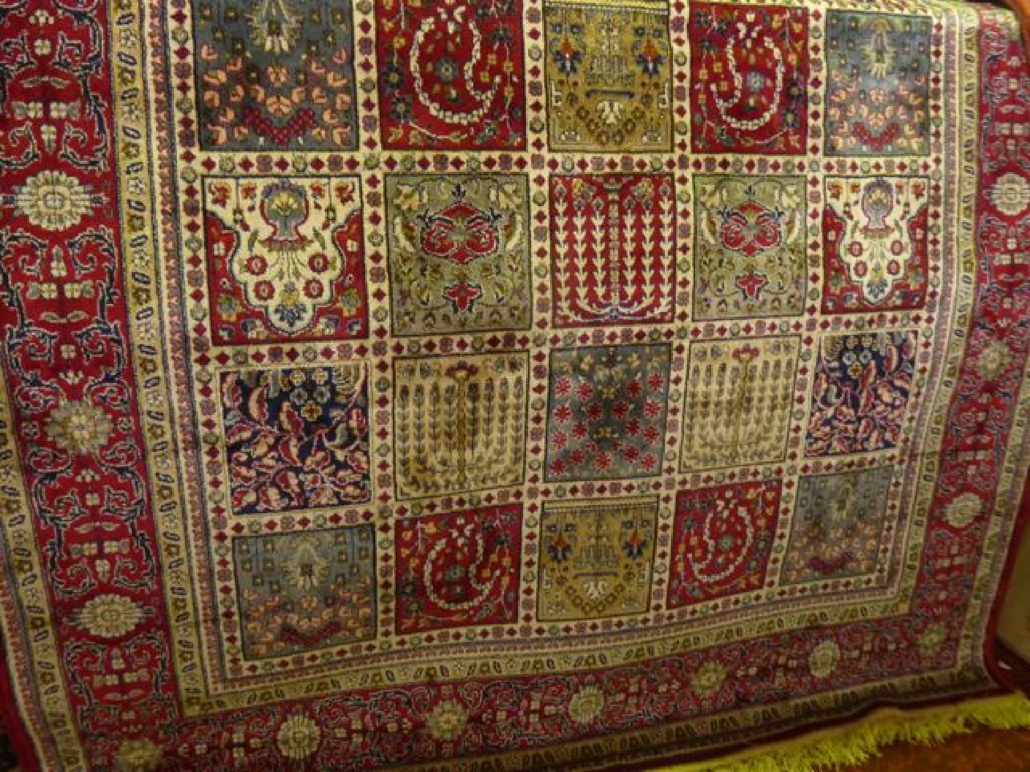 Appraisal: A Persian style wool rug with multi-medallion centre showing flowers