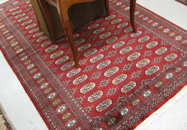 Appraisal: PAKISTANI-BOKHARA CARPET repeating columns of Turkoman gols on red ground