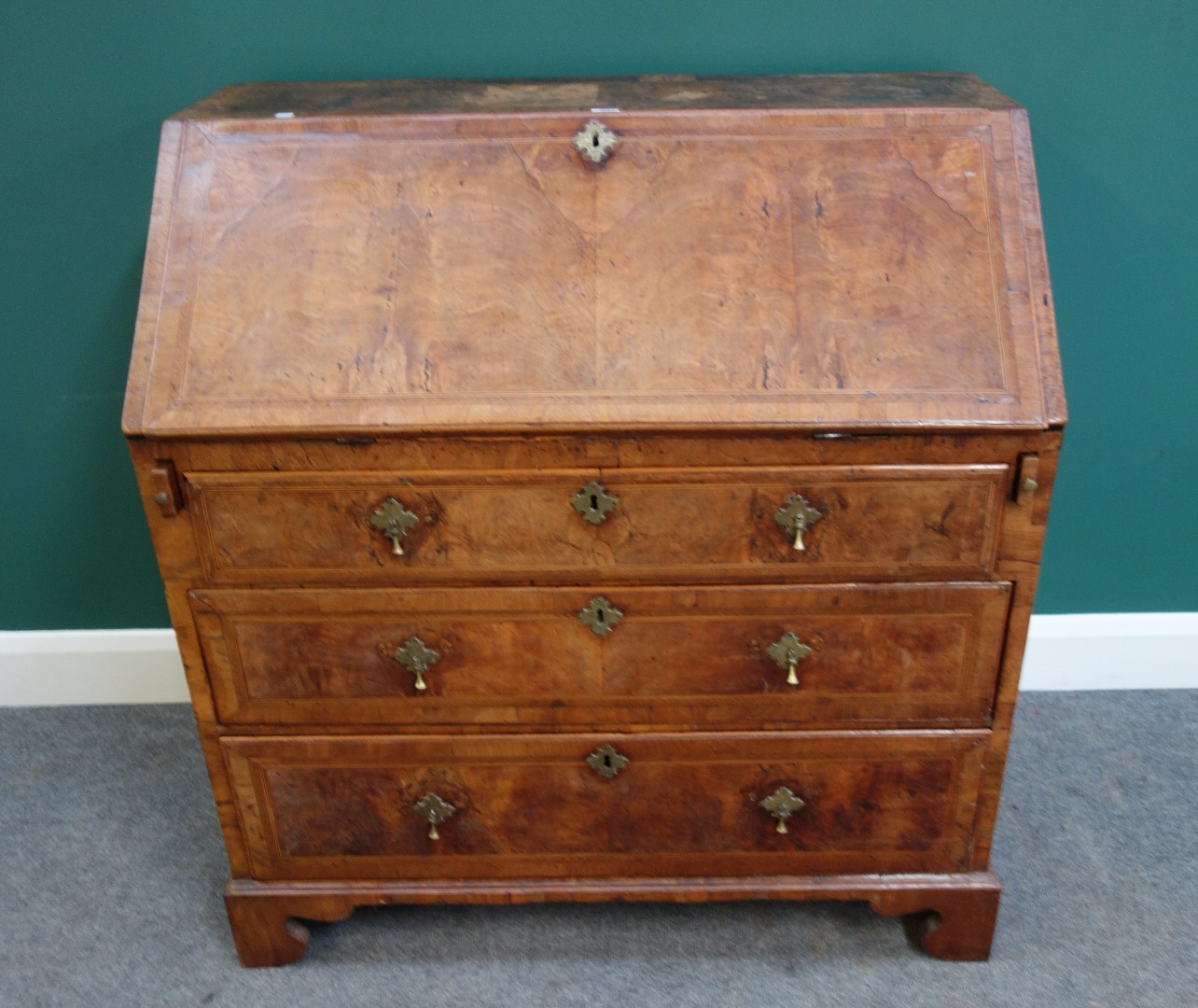 Appraisal: A mid- th century feather banded figured walnut bureau the