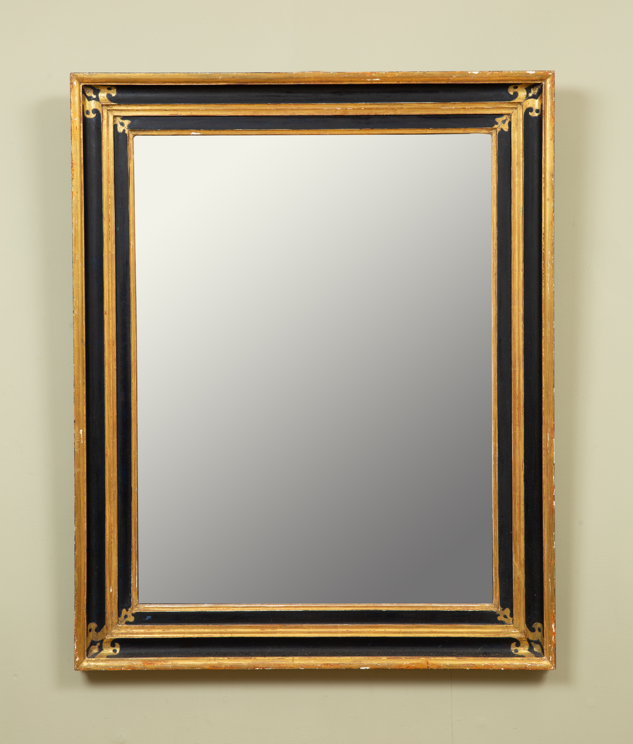 Appraisal: A rectangular wall mirror with simple black and gold painted