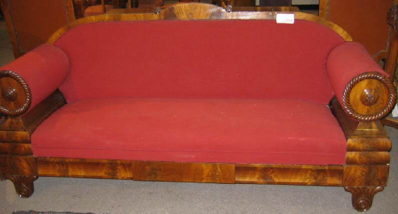 Appraisal: AMERICAN EMPIRE MAHOGANY SETTEE Showing a simple arched back rail