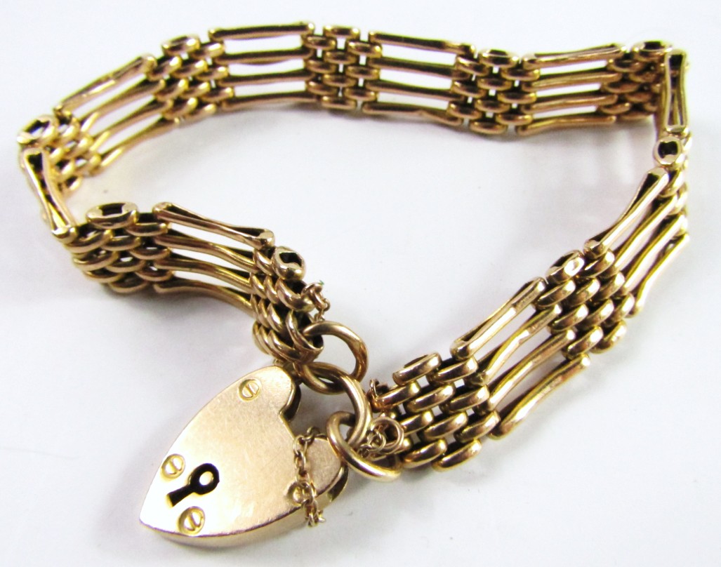 Appraisal: A ct gold four bar gate bracelet on a heart