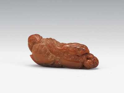 Appraisal: A Carved Horn Figure of a Shishi Lion Elongated carved