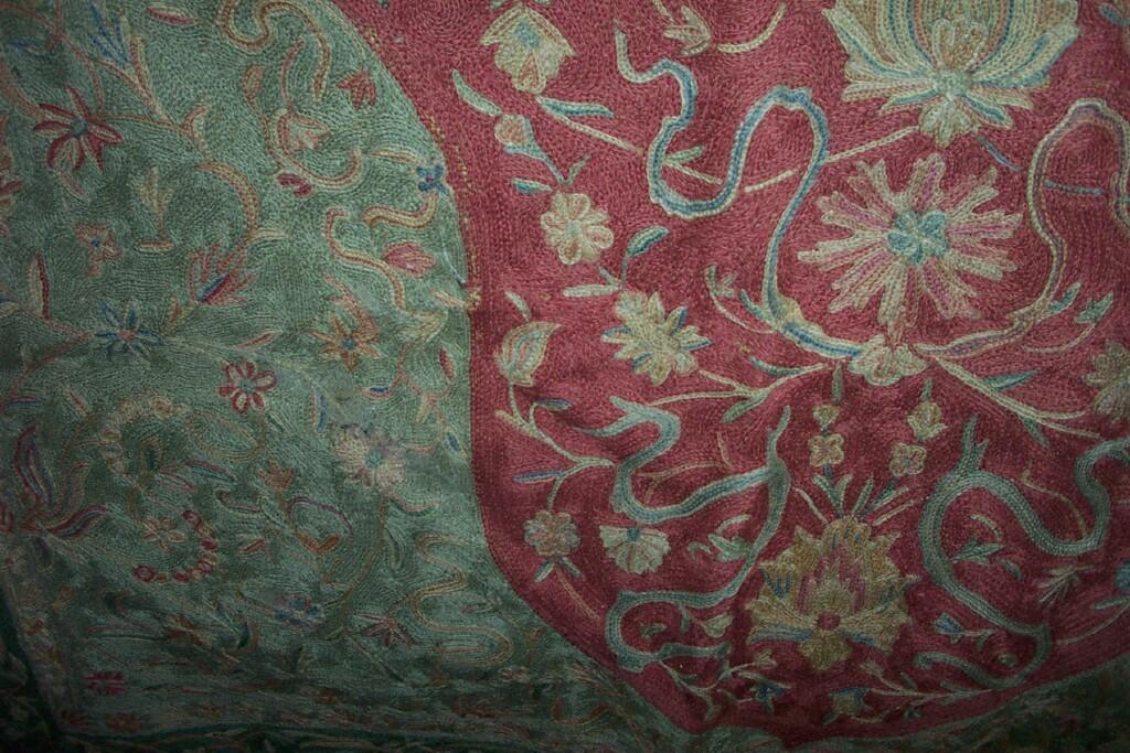 Appraisal: A chain stitch prayer rug in pink and green with