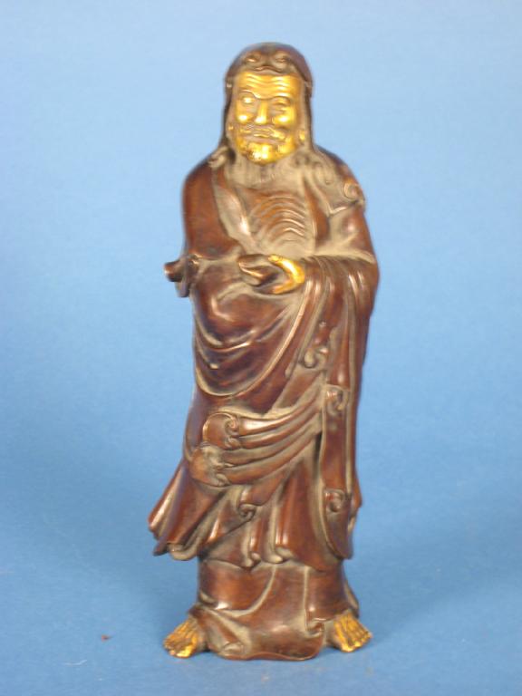 Appraisal: A Chinese bronze figure of a man in robes with