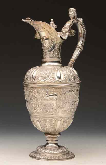 Appraisal: A VICTORIAN ARMADA CLARET JUG with chased satyrs animals and