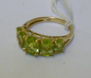 Appraisal: A PERIDOT DRESS RING claw set with five graduating faceted