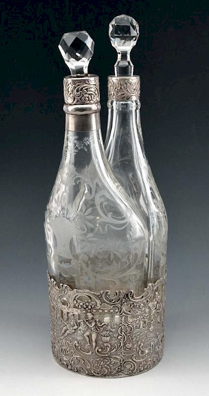 Appraisal: Fine two-bottle etched glass decanters in silver base Fine two-bottle