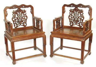 Appraisal: A pair of Chinese hardwood open armchairs the carved and