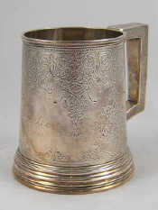 Appraisal: A Victorian silver chased and engraved mug with glass bottom