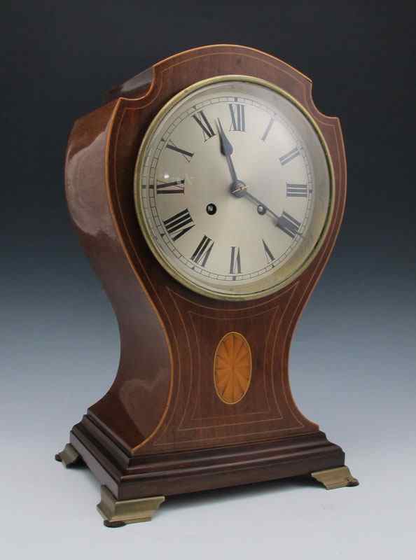 Appraisal: PEERLESS TWIN TRAIN INLAID BALLOON CLOCK Wood case with patera