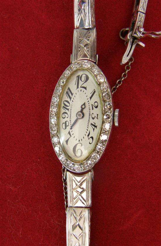 Appraisal: Diamond set cocktail watch with white oval dial and articulated