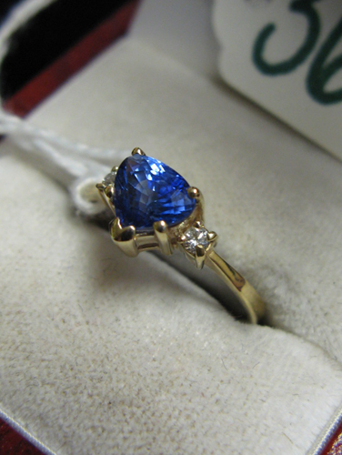 Appraisal: SAPPHIRE DIAMOND AND FOURTEEN KARAT GOLD RING centering a trilliant-cut