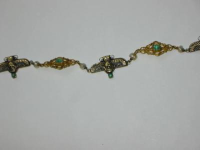 Appraisal: A FRENCH GOLD BRACELET with alternating links of winged Aztec