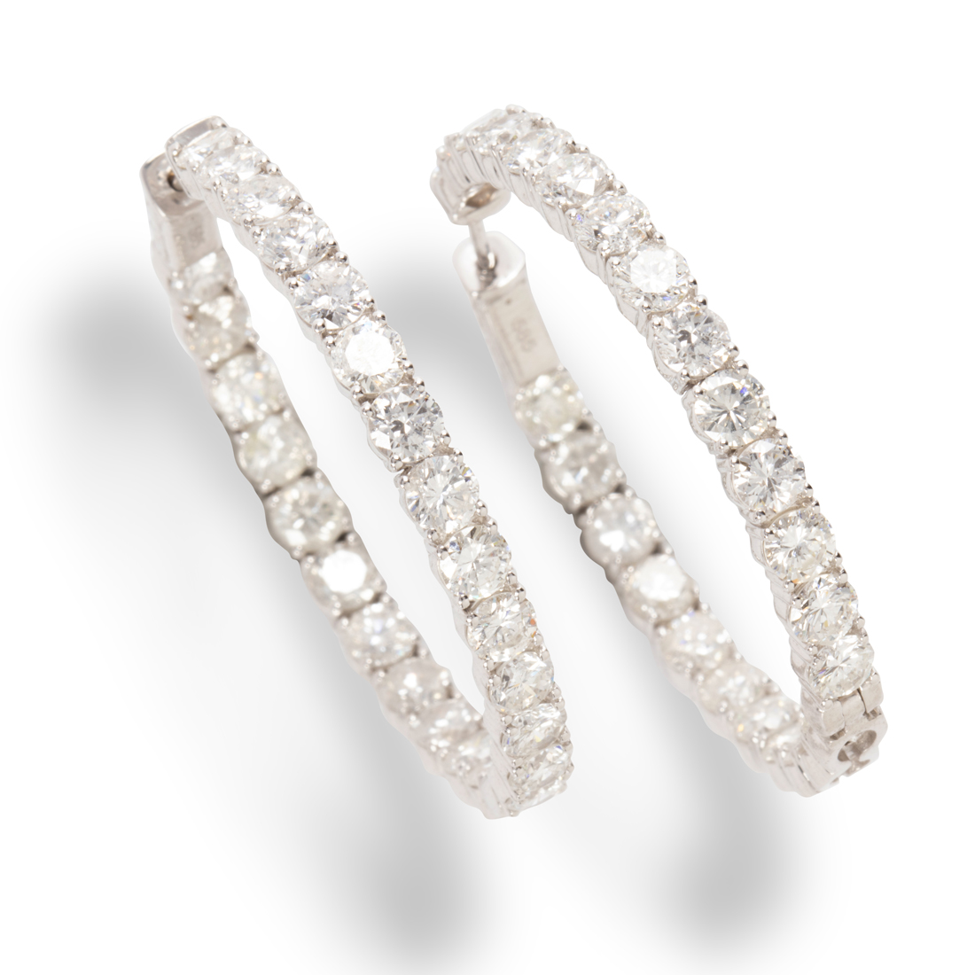 Appraisal: A PAIR OF DIAMOND AND FOURTEEN KARAT WHITE GOLD HOOP