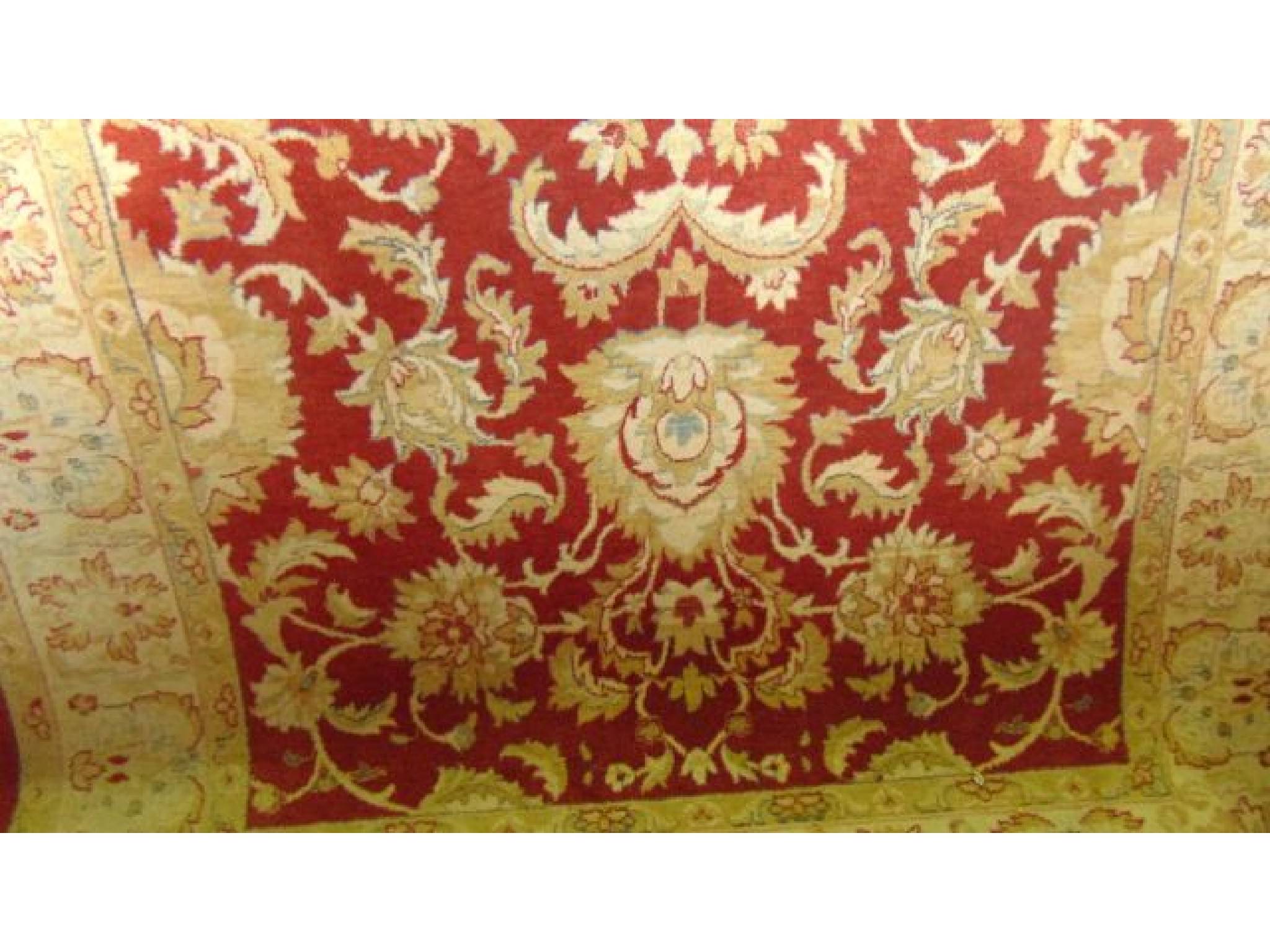 Appraisal: A large wool work carpet with floral detail upon a