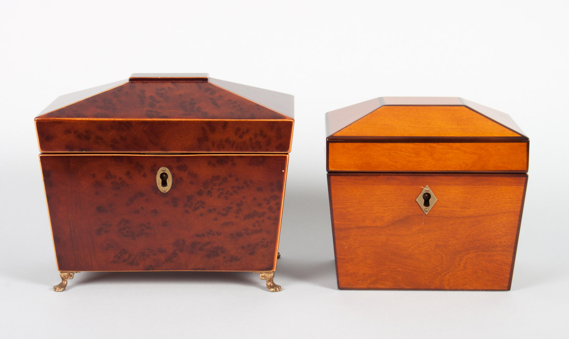 Appraisal: Two George III style tea caddies bird's-eye maple sarcophagus form