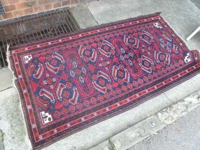 Appraisal: AN HAMADAN BLUE GROUND RUG with traditional geometric designs x