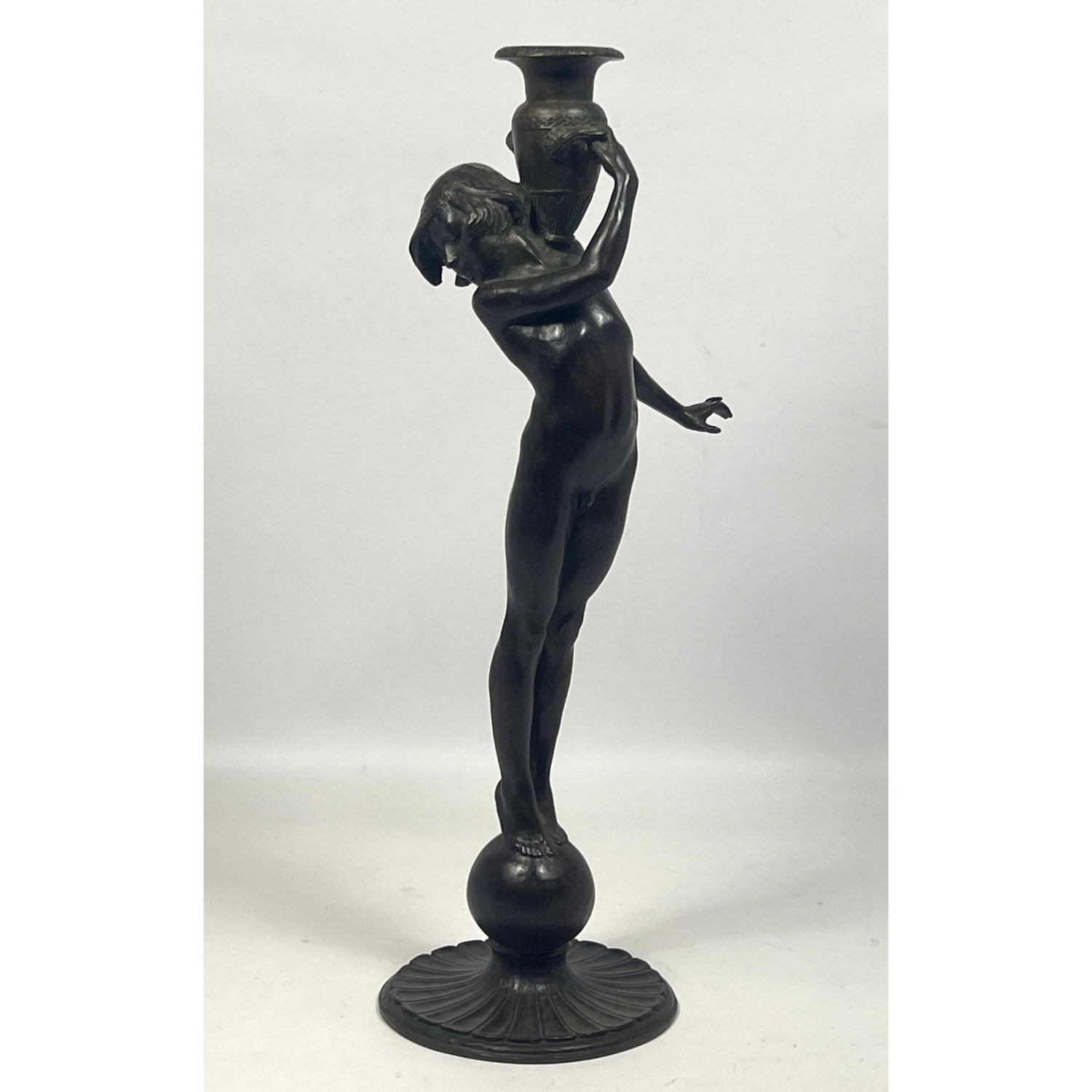 Appraisal: Edward Francis McCartan Waterbearer candleholder Candlestick Youthful figure in playful