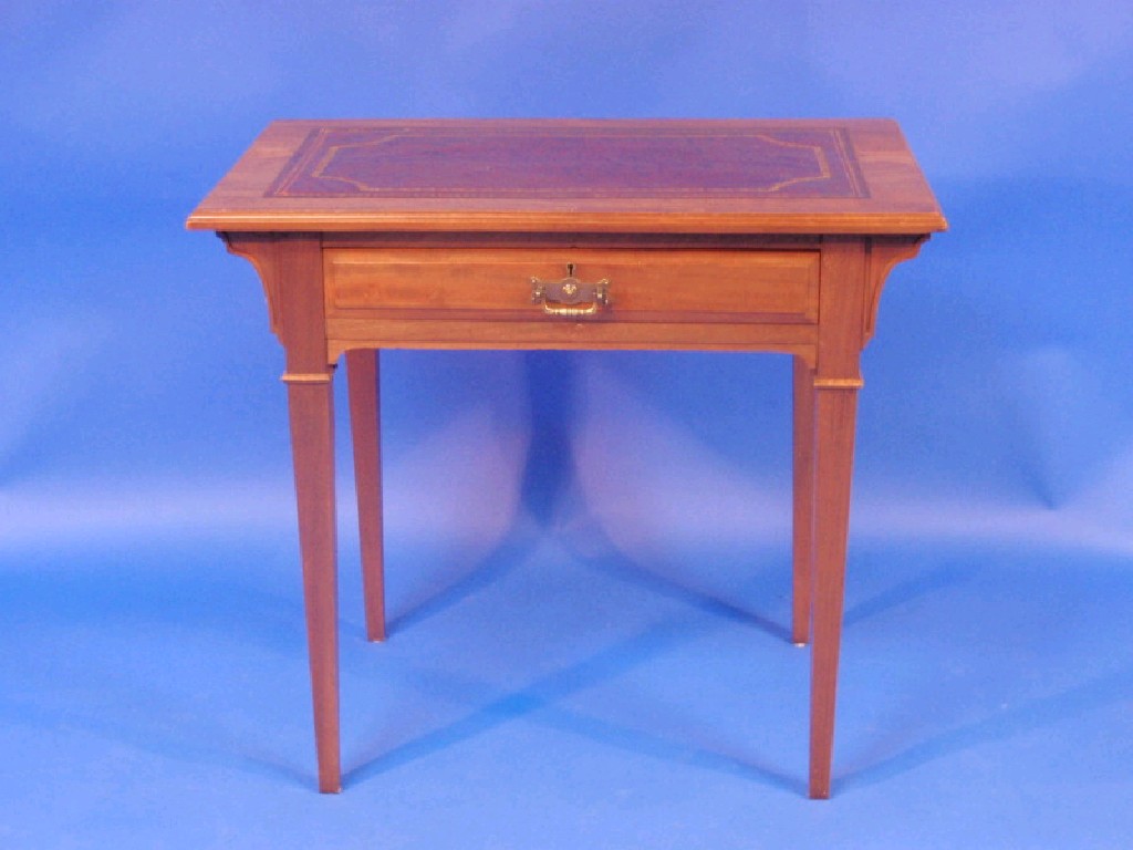 Appraisal: An Edwardian walnut writing table with leather inset top single