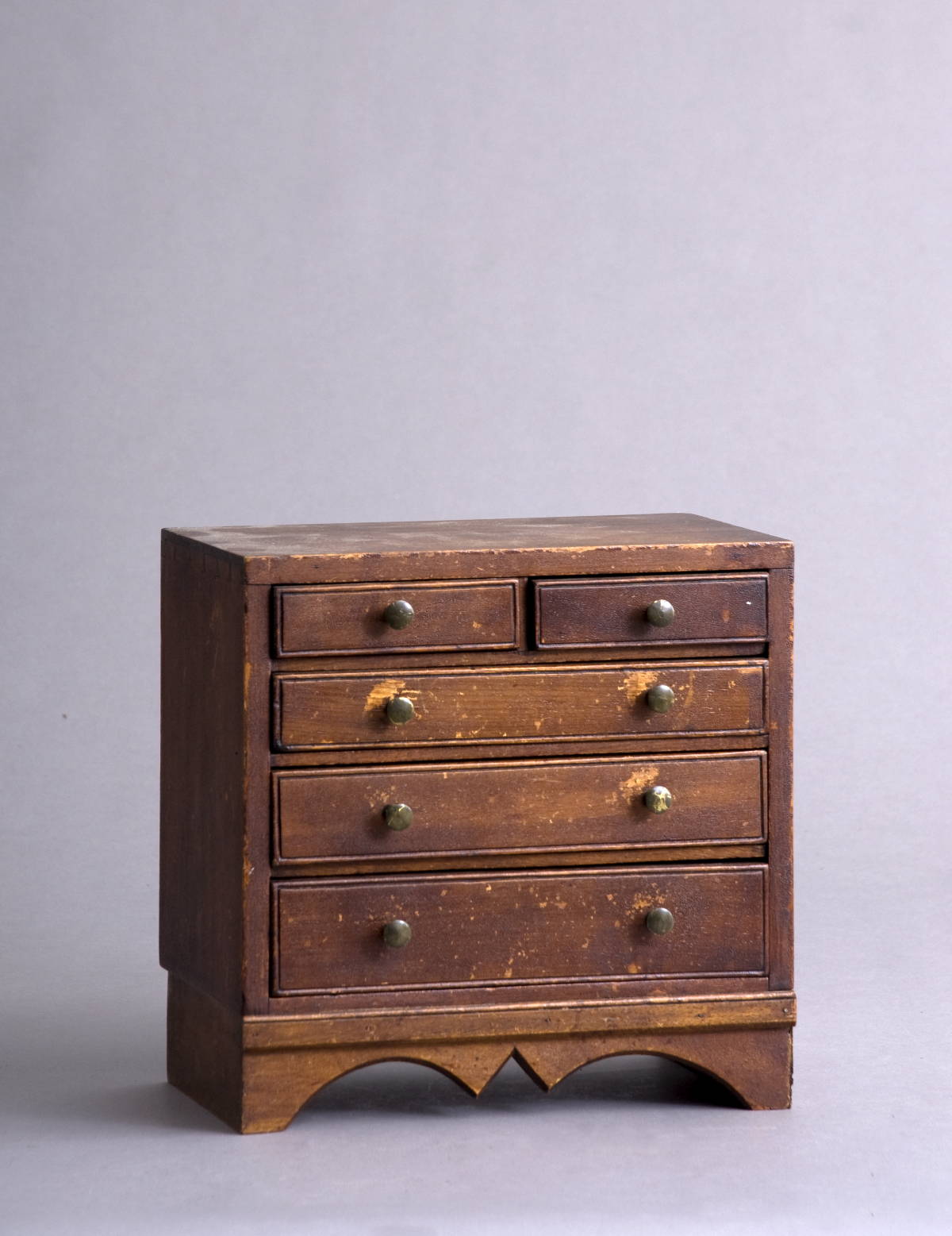 Appraisal: MINIATURE HARDWOOD CHEST OF DRAWERS WITH SHAPED APRON Height inches