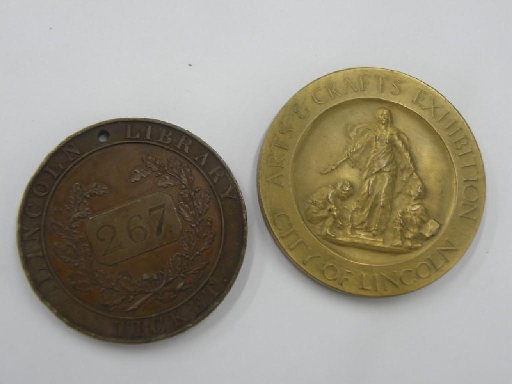 Appraisal: A bronze Lincoln Library ticket or token and a medallion