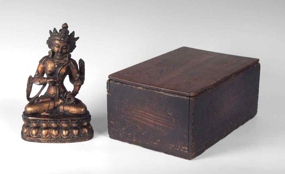 Appraisal: TIBETAN BRONZE BUDDHA IN WOODEN BOX Seated Tibetan Buddha holding