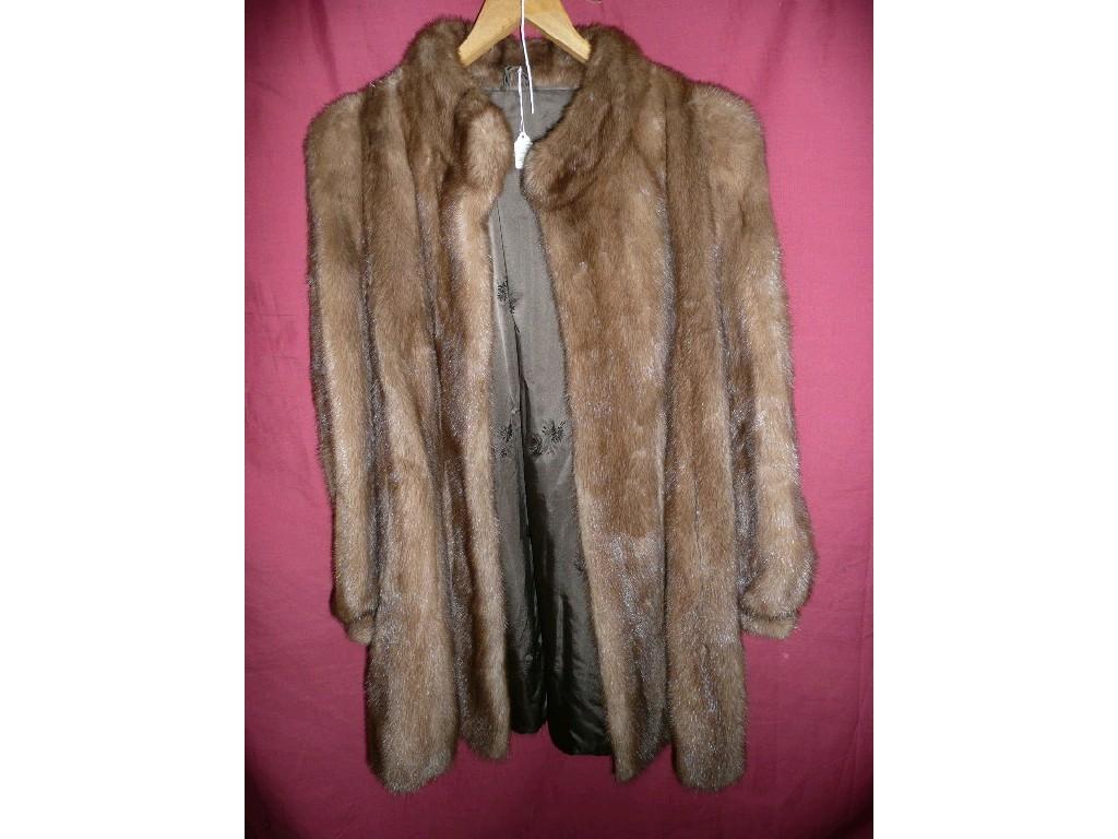 Appraisal: A vintage fur coat in soft brown padded shoulders lined