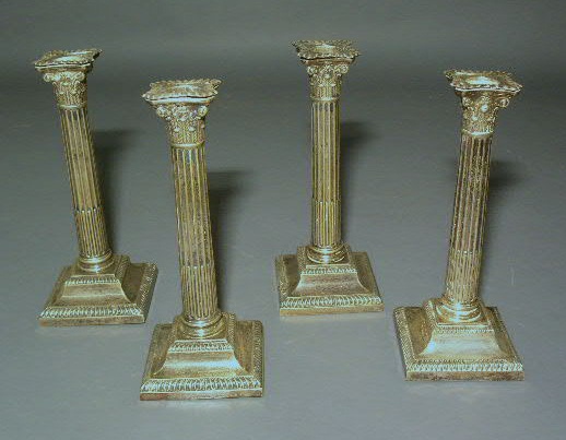 Appraisal: Set of four weighted Corinthian candlesticks h base x