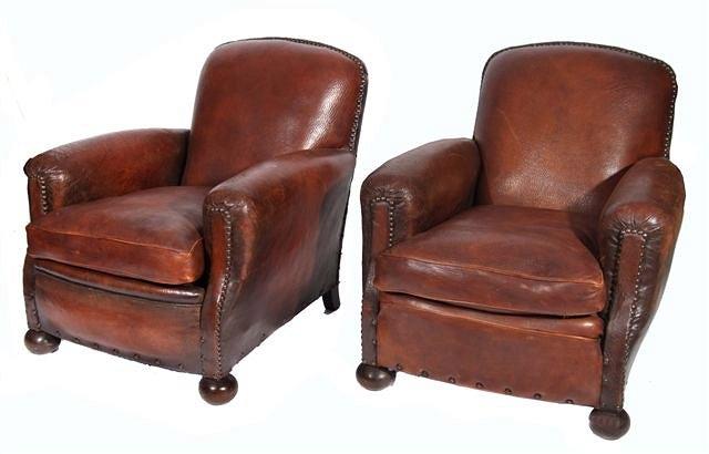 Appraisal: A PAIR OF BROWN STUDDED LEATHER CLUB ARMCHAIRS with loose