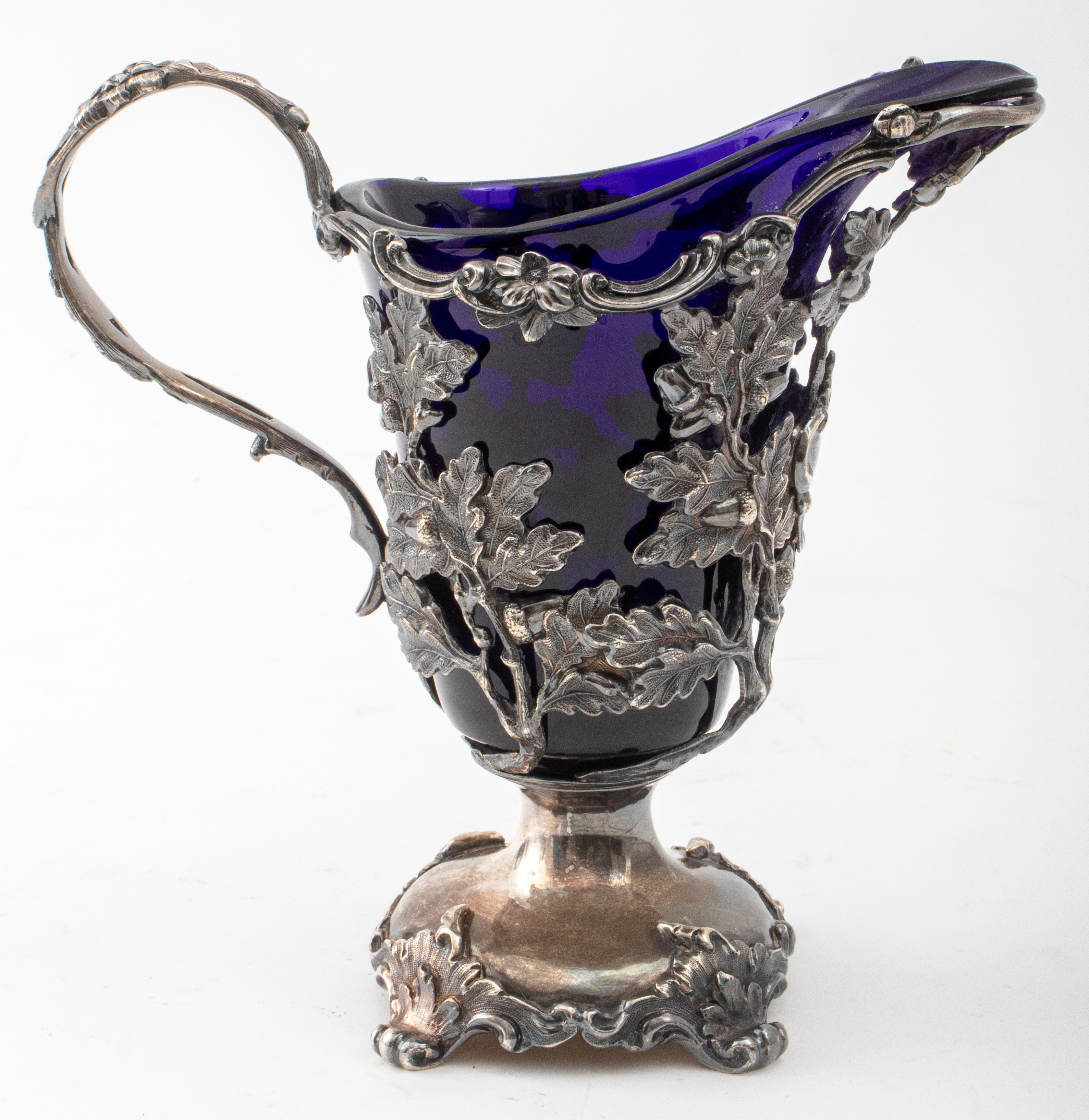 Appraisal: SILVERPLATE COBALT BLUE GLASS FOLIATE PITCHER Silverplate cobalt blue glass