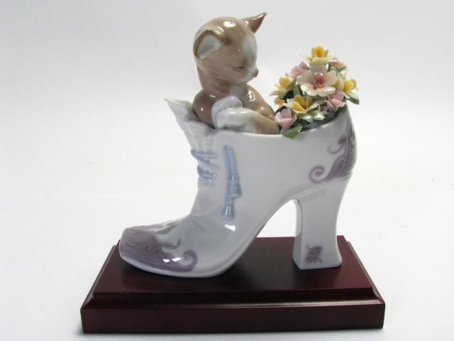 Appraisal: Lladro Figurine Cozy Fit retired approximately '' high on wood