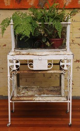 Appraisal: TWO VICTORIAN CAST-IRON AND GLASS TERRARIUMS One terrarium on later