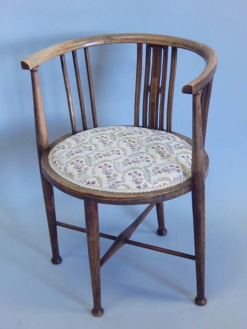 Appraisal: An Edwardian stained beech and boxwood strung tub shaped chair