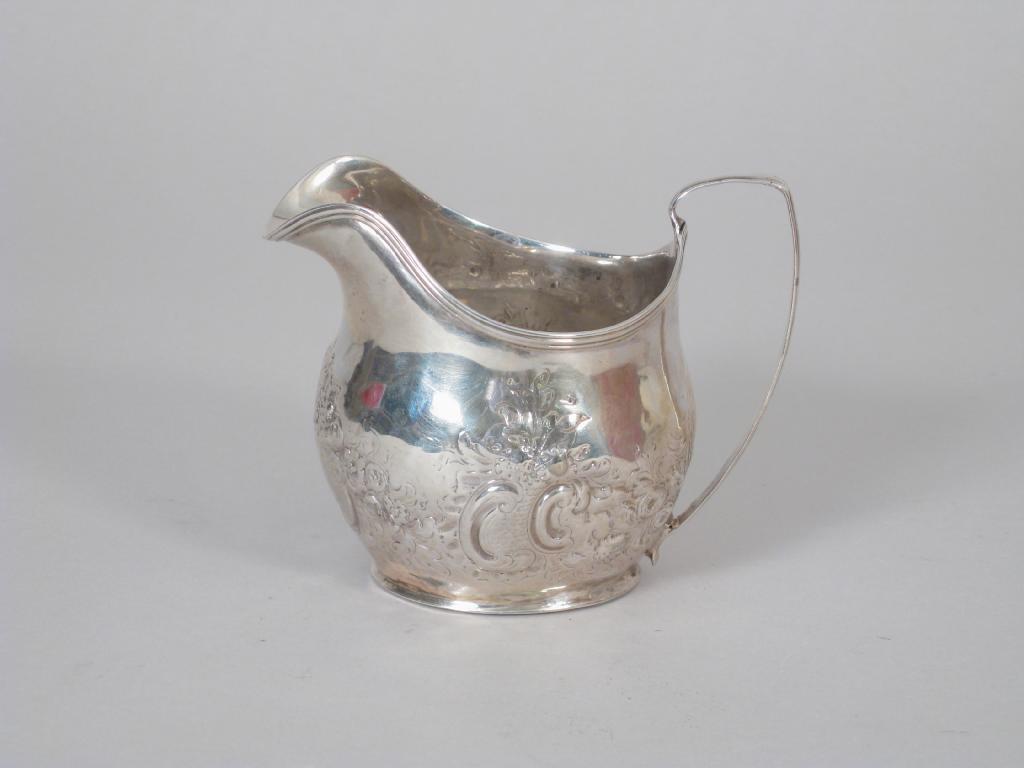 Appraisal: A George III Cream Jug with floral embossing and vacant