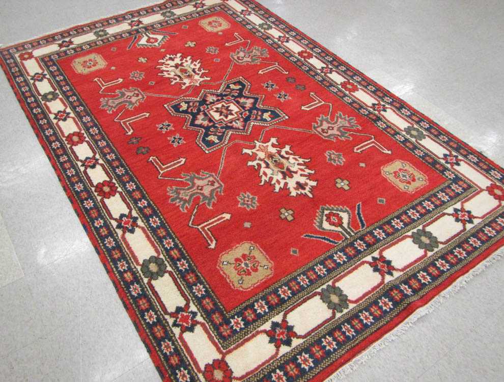 Appraisal: HAND KNOTTED ORIENTAL CARPET Indo-Persian tribal geometric and curvilinear decoration