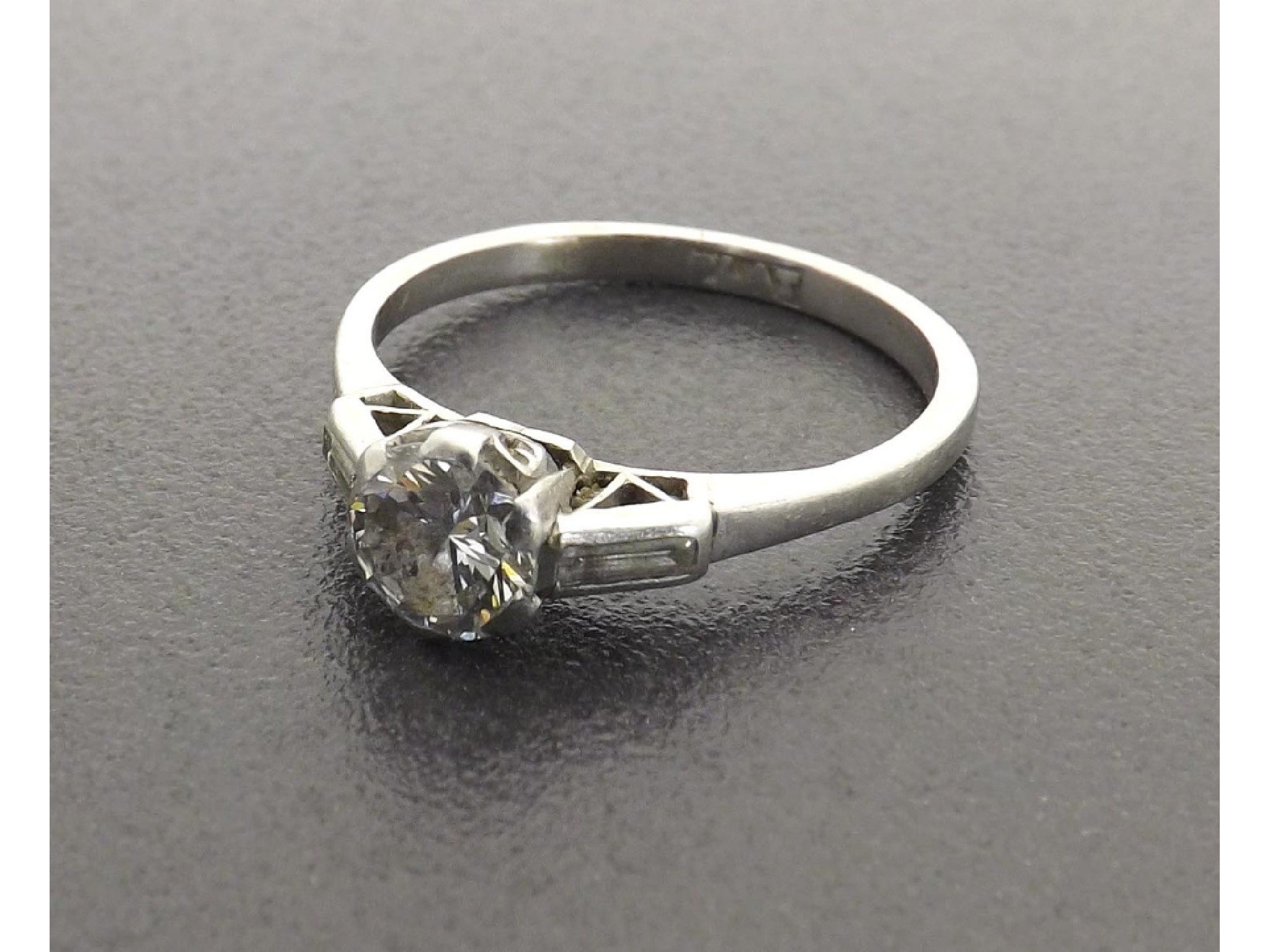 Appraisal: Platinum solitaire diamond ring with baguette-cut set shoulders round brilliant-cut