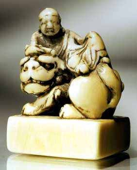 Appraisal: ANTIQUE IVORY NETSUKE Well carved and antique ivory netsuke of