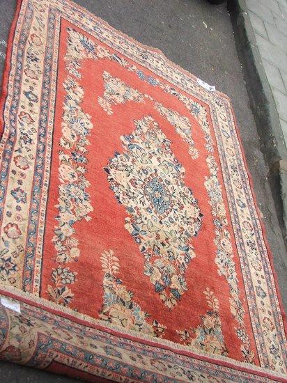 Appraisal: A HAMADAN RUST GROUND RUG decorated a central medallion within