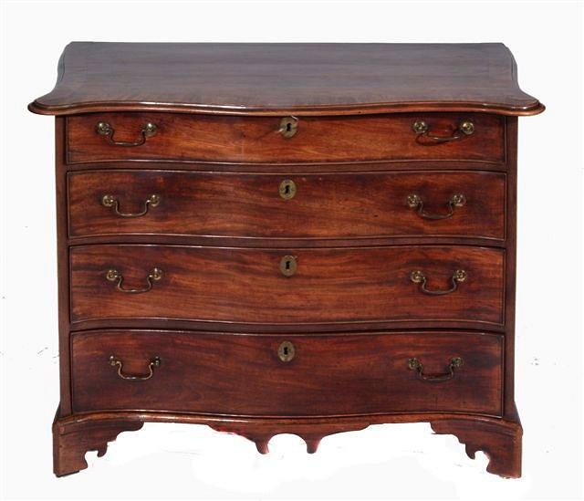 Appraisal: A GEORGE III MAHOGANY SERPENTINE CHEST of four long graduating