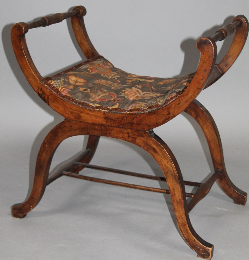 Appraisal: A thC mahogany framed Glastonbury style stool the shaped arms